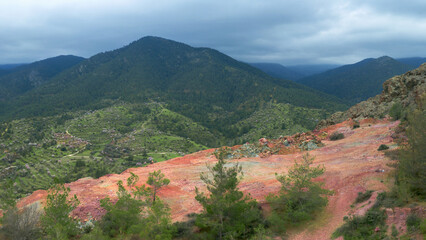 Abandoned open pit mine on mount Alestos, Cyprus. Red soil rich of iron and copper
