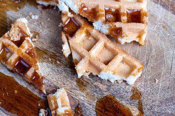 Soft fresh waffles with bee honey close-up