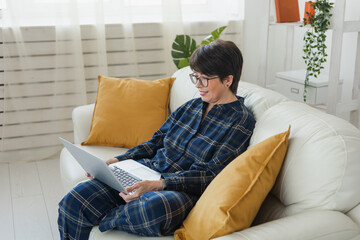 Work online remote from home concept. Woman relaxing in pajama while video call meeting