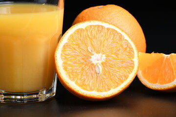 Halved orange and orange juice in a glass