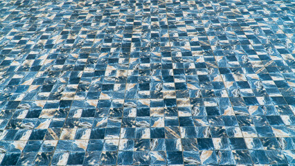 Fototapeta premium Marble tile floor with sea wave water design pattern. Marble tile floor with blue checkered pattern.