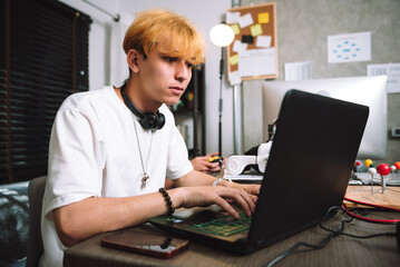 Caucasian young men using laptop for freelance programmer coding work at home, Work overtime concept.