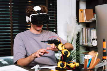 Caucasian young man studying by self in robotic system and Virtual Reality vr glasses controller , freelance programmer coding work at home.