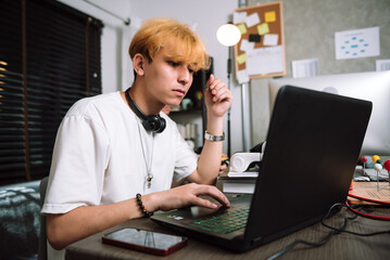 Caucasian young men using laptop for freelance programmer coding work at home, Work overtime concept.