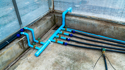 Drip irrigation pipe valve system at farm in greenhouse. Water pipes valve or plumbing connect in...