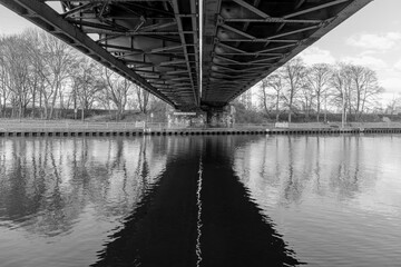 Fototapeta premium Underside of railroad bridge over a canal in Oberhausen, Germany