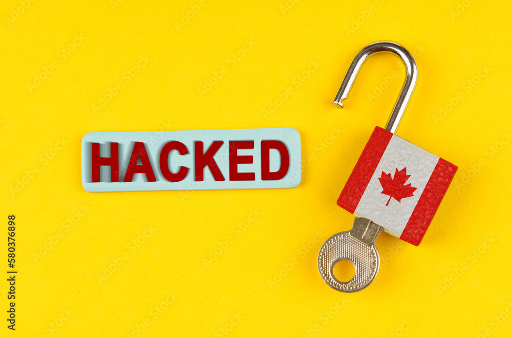 Poster on the yellow surface is an open lock with a key and a sticker with the inscription - hacked