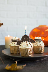 Cupcakes decorated for Halloween on a gray plate on a gray background.