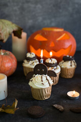 Cupcakes decorated for Halloween on a gray background.