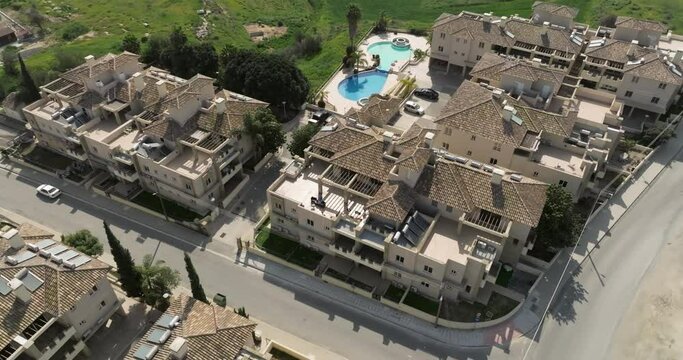 Aerial view of country houses with a swimming pool in a green place. Residential complex with quiet streets with the latest architecture. High quality 4k footage