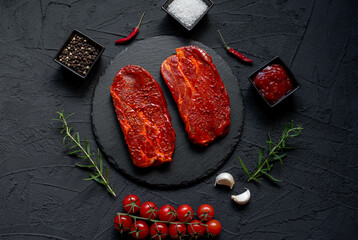 marinated raw pork steaks on stone background 