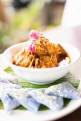 'Hung Lay' curry with pork served with steamed glutinous rice. This curry from northern Thailand is like no other. Slow-simmered, slightly sweet and tangy, and full of rich, complex flavors.