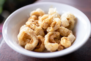 Deep-fried skin pork or crispy pork rinds in a bowl.