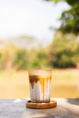 Dirty coffee on table in the garden with shade of sunlight. Good time with coffee.