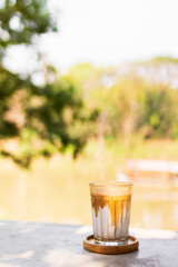 Dirty coffee on table in the garden with shade of sunlight. Good time with coffee.
