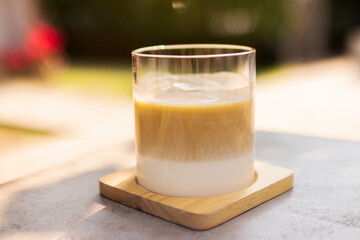 Latte coffee on table in the garden with shade of sunlight. Good time with coffee.