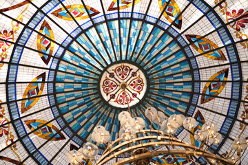 part of a Gothic-style stained glass ceiling, made of colored glass. The shapes and colors are just stunning, and the sunlight creates such a playful play of light and shadow.