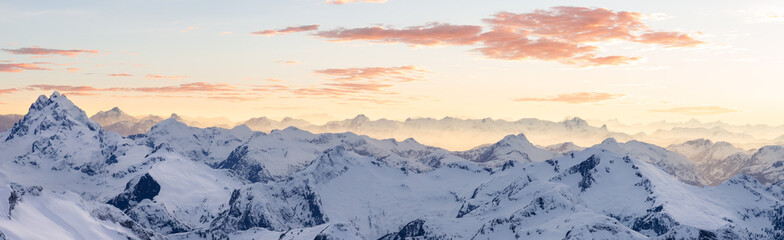 Fototapeta premium Aerial View from Airplane of Snow Covered Canadian Mountain Landscape in Winter. Colorful Pink Sky Art Render. Near Squamish, North of Vancouver, British Columbia, Canada. Panorama