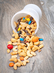 Fruit and nuts with candy in a white bowl