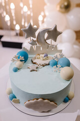 Birthday cake with blue decor on a background balloons. Baby shower party, newborn. Celebration baptism concept. Copy space. Celebration concept. Trendy winter Cake. Delicious reception. Close up.