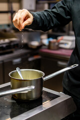 Chef hands cooking sauce in the restaurant kitchen