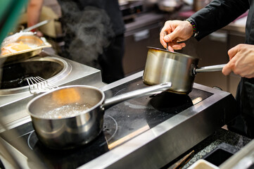 Chef hands cooking sauce in the restaurant kitchen