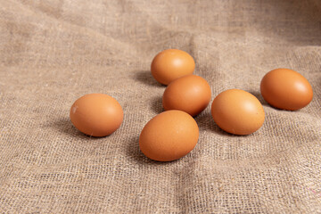 Chicken eggs on burlap background. Fresh eggs