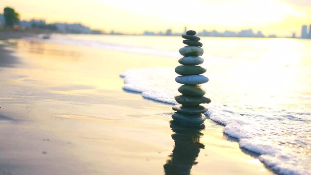 beautiful reliable and stable Zen pyramid of stones on the ocean beach ,the concept of the idea of balance and stability