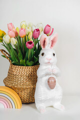 Spring flowers, Easter Bunny and eggs. Home interior with easter decor.   Children's room in the Easter style. Holidays decorations.