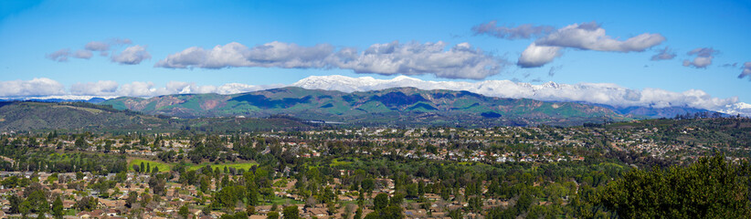Fototapeta na wymiar Panoramic view of snow mountains and citrus trees and Santa Rosa Valley and homes Ventura California during winter snow storms 