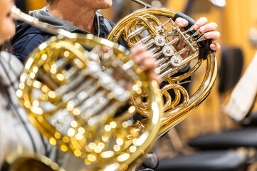French horn instrument, hands playing horn player in philharmonic orchestra