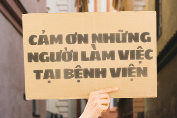 The phrase " Thank you hospital workers " on a banner in hand. The Human holds cardboard with an inscription. Gratitude to healthcare staff. Heroes. People who save lives. Thankfulness. Life