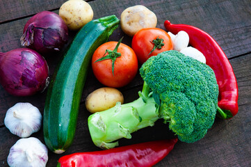 Dietary and healthy food times. Top view of fresh vegetables on rustic wooden table.