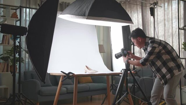 Asian Male Photographer Celebrating Succeed Taking Photos Of Women'S Shoes In Home Studio 
