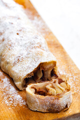 apple strudel on wooden board