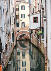 Venice, Italy - 14 Nov, 2022: Reflections on a backstreet canal in San Marco