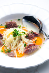 beef broth with noodles and carrot