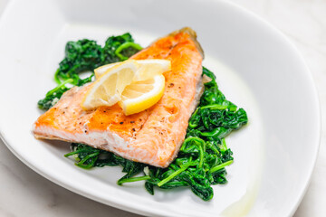 grilled salmon fillet with spinach leaves salad