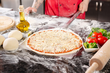 pizzaiolo prepares pizza in the kitchen, the chef prepares the dough