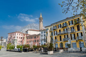 Mario Cermenati square of Lecco town, situated nearby to the memorial Monument of Mario Cermenati and the church Minor Basilica of San Nicolo. Spring morning in Lecco, Lombardy, Italy.