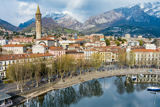 Sunny aerial cityscape of Lecco town on spring day. Picturesque waterfront of Lecco town located between famous Lake Como and scenic Bergamo Alps mountains.