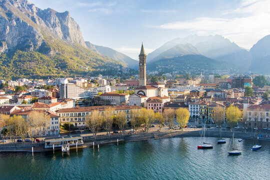 Sunny aerial cityscape of Lecco town on spring morning. Picturesque waterfront of Lecco town located between famous Lake Como and scenic Bergamo Alps mountains.
