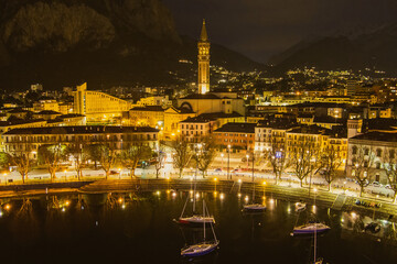 Nighttime aerial cityscape of Lecco town. Picturesque waterfront of Lecco town located between famous Lake Como and scenic Bergamo Alps mountains.