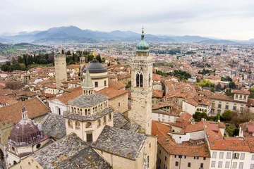 Deurstickers Scenic aerial view of Bergamo city. Flying over Citta Alta, town's upper district, known by cobblestone streets and encircled by Venetian walls. Bergamo, Lombardy, Italy. © MNStudio
