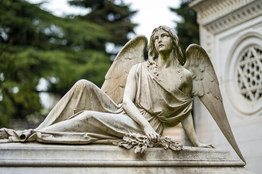 Impressive sculptures on the tombs and monuments of Cimitero Monumentale di Milano or Monumental Cemetery of Milan. Milan, Italy.