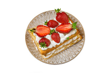 Puff pastry cake with whipped curd cream and fresh strawberries isolated on white background