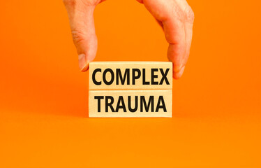 Complex trauma symbol. Concept words Complex trauma on wooden block. Beautiful orange table orange...