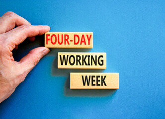 Four-day working week symbol. Concept words Four-day working week on wooden block on a beautiful blue table blue background. Businessman hand. Business four-day working week concept. Copy space.