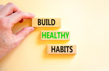 Motivation and Build healthy habits symbol. Concept words Build healthy habits on wooden block on a beautiful white table white background. Business build healthy habits concept. Copy space.