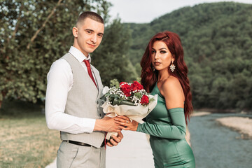 Young prom couple. Boy gives bouquet to his prom date © stivog
